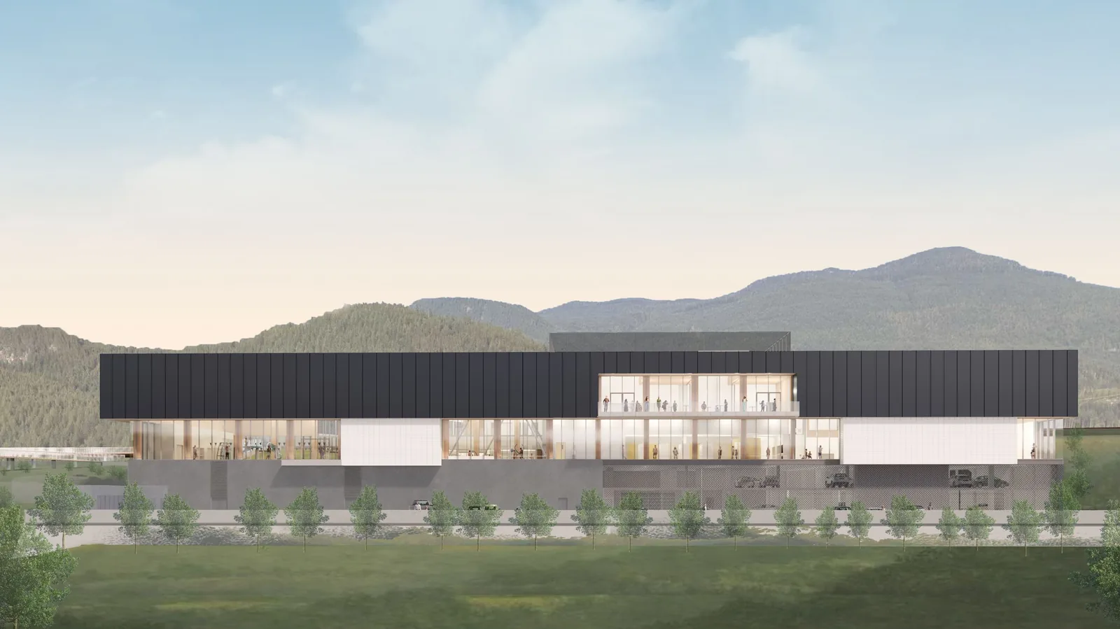 Burke Mountain Community Centre wide elevation rendering — two-storey facility with dark cladding and warm-wood interior glow, mountains in the background