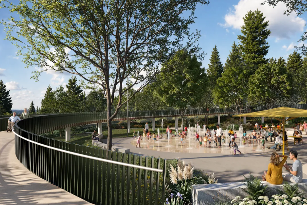 Families at the Burke Village Park water play feature, seen from the elevated pathway