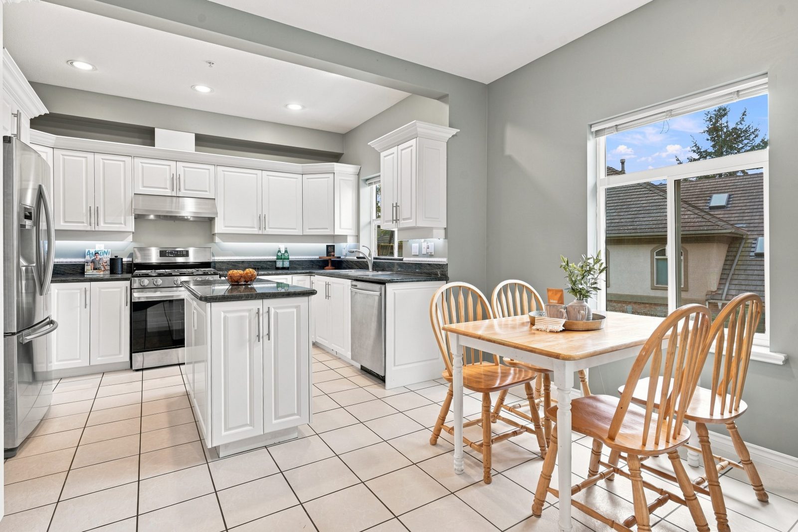 Breakfast nook with table and chairs beside the kitchen at #11 915 Fort Fraser Rise