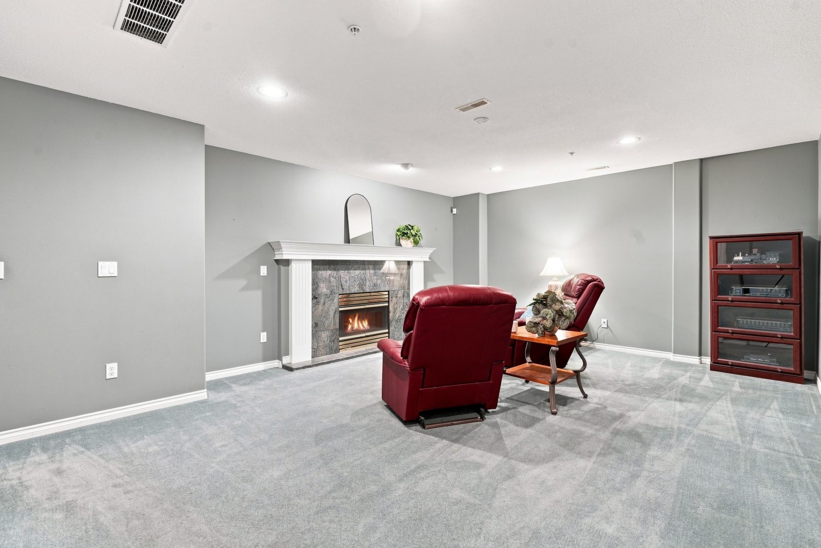 Large lower-level recreation room with fireplace at #11 915 Fort Fraser Rise