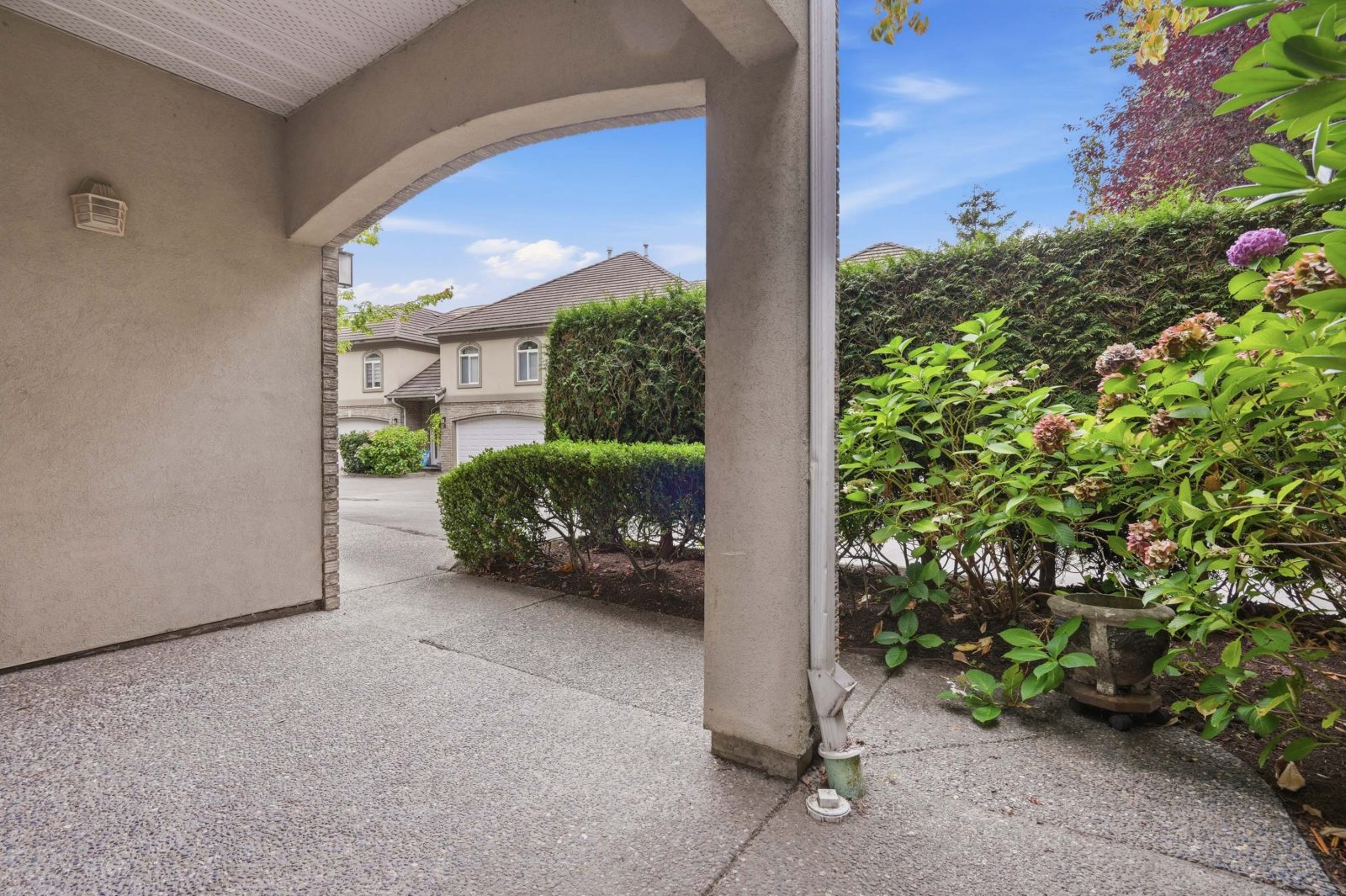 Covered patio with hedges and greenery at #11 915 Fort Fraser Rise, Port Coquitlam