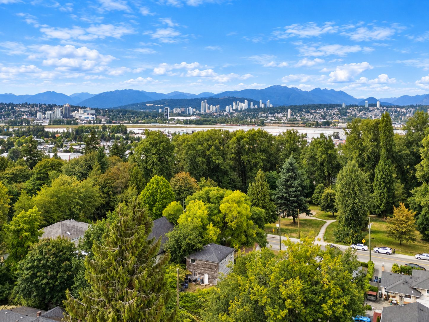 View from 13090 111 Avenue area over rooftops and trees toward the mountains
